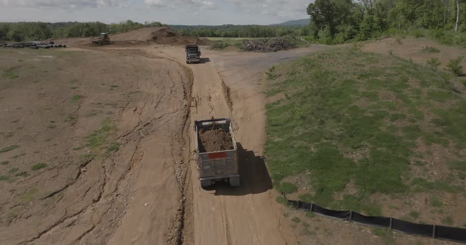Aerial of a moving truck carrying sand at daytime