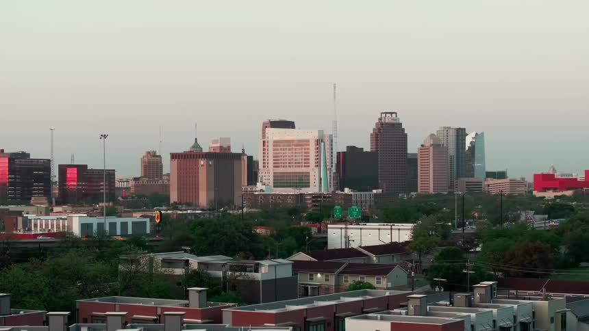 Tall buildings are in the distance in the city