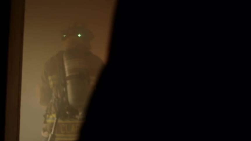 Firefighters enter the burning home
