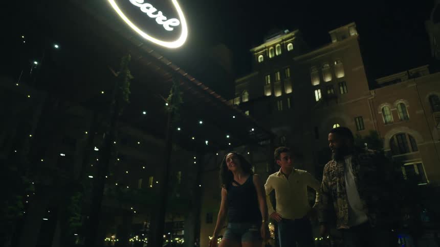 Friends are walking at night in the city