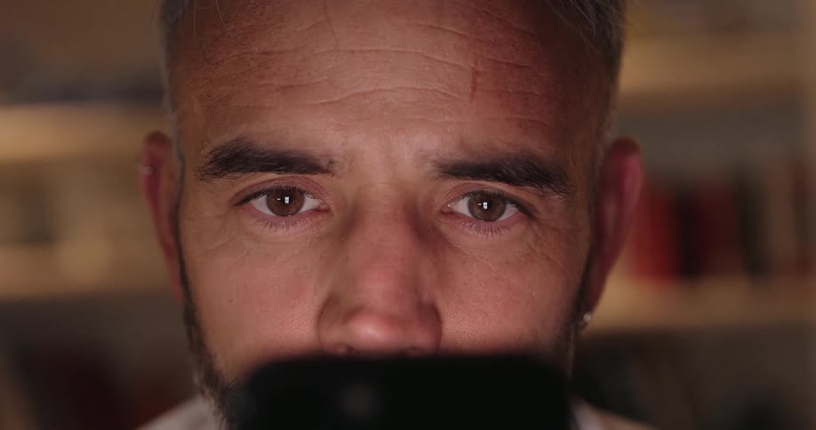 Man scans the contents of a smartphone screen