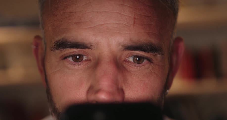 Light reflects on the mans eyes