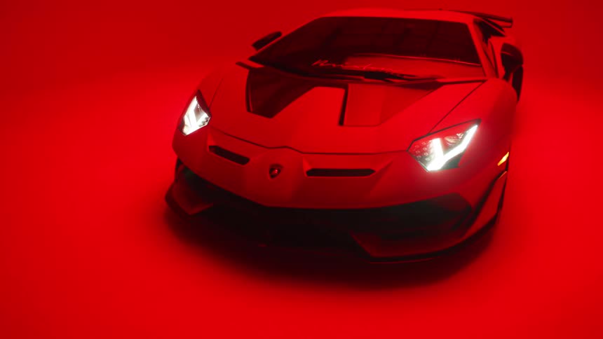 Lamborghini with headlights on in a studio