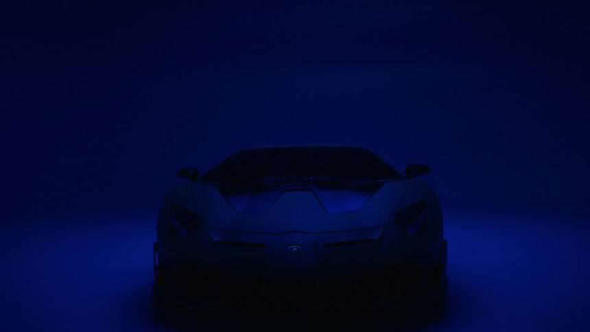 A modern sports car glows with blue illumination in a dimly lit room