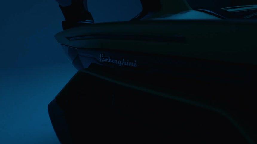 A closeup shot of a lamborghinis blinking taillight in a dark moody bluelit setting