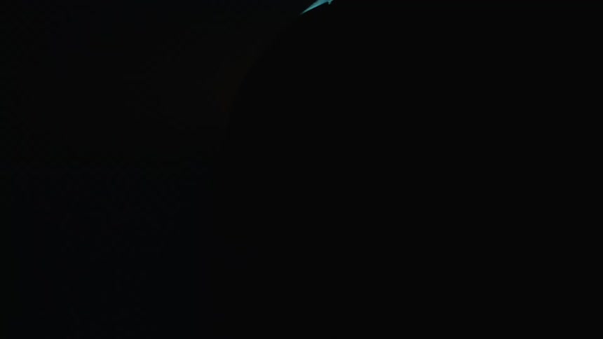 Blue light flashes to illuminate a parked sports car