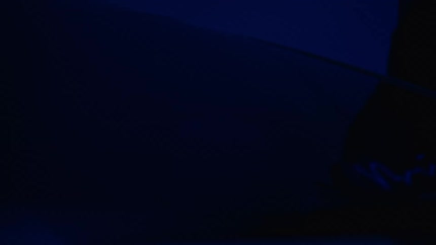 Person looking at car in the dark