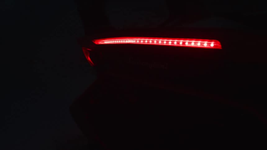 A parked car has its break lights on