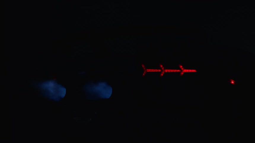 Metal with red lights is under a blinking blue light