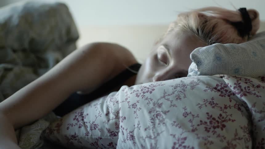 A woman laying in bed sleeping