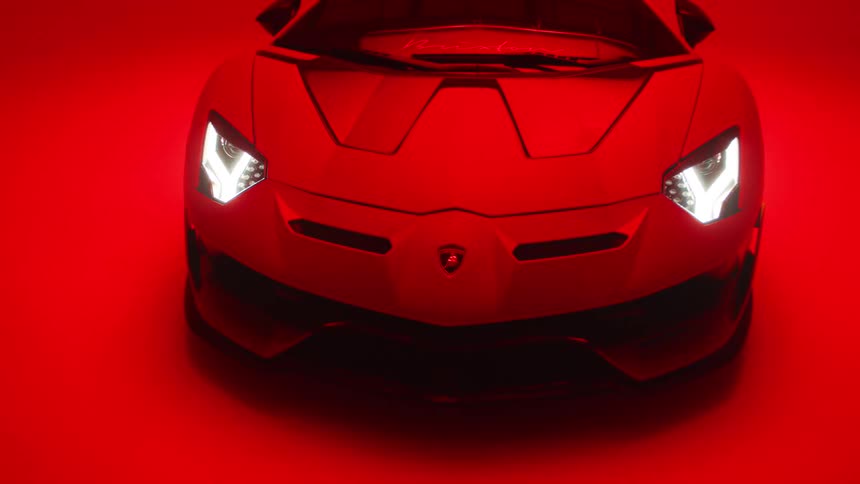 The lamborghinis headlights are on in the dark