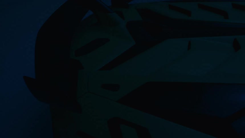 View of the wing spoiler of a sports car in a garage with blinking blue lighting