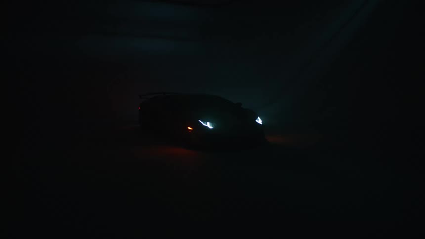The headlights shine in the dark area