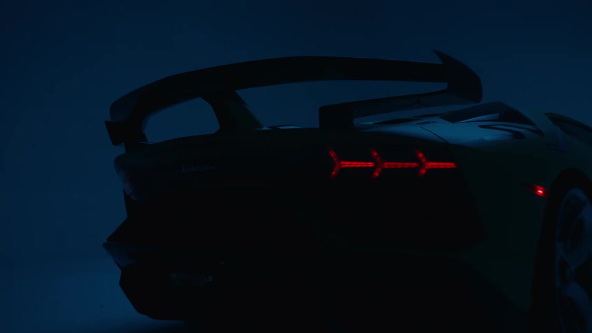 A sleek sports car with blinking red taillights is dramatically silhouetted in a dark moody setting