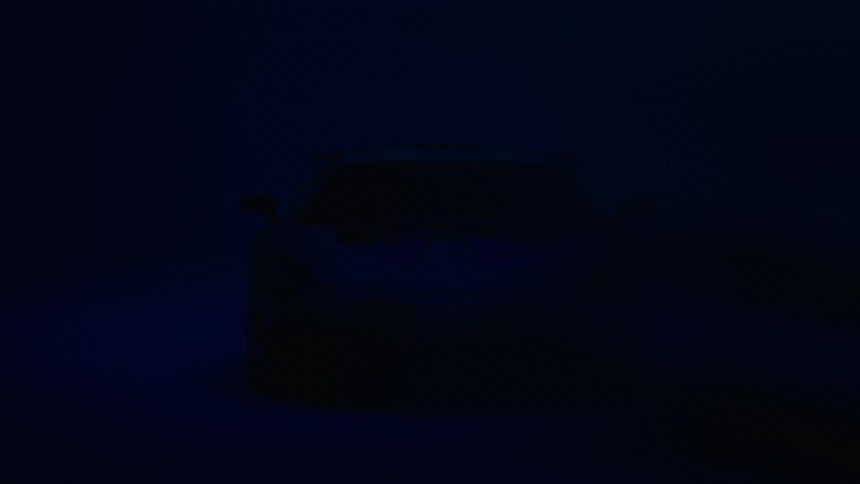 A sleek sports car emerges from the shadows in a dark bluelit setting