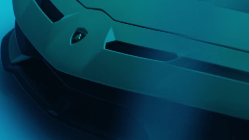 A lamborghini sits indoors in a dark room with flickering light