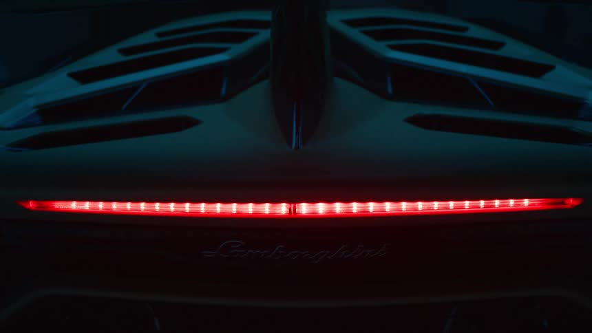 Lamborghinis led taillight lights up in a solid red line in low light