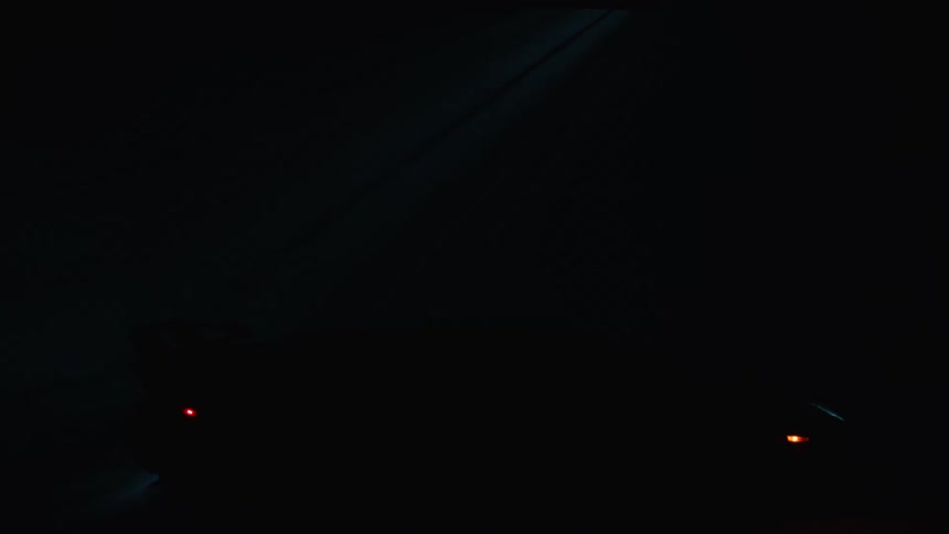 The sports car is parked in the dark