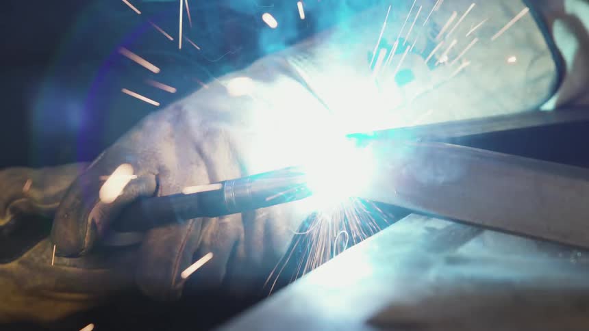 A man welding a piece of metal