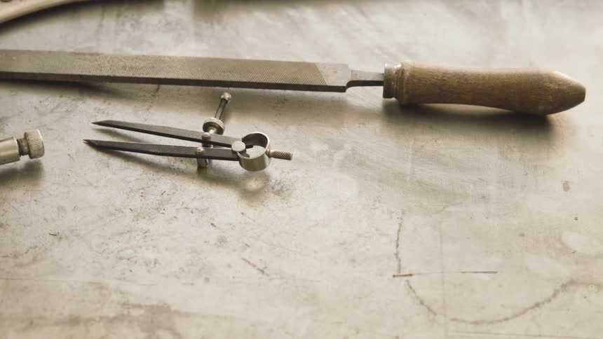 A person in gloves moves some tools