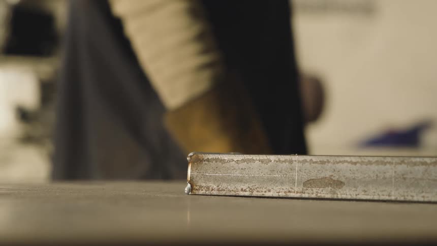Closeup of a metal bar in an industrial workspace