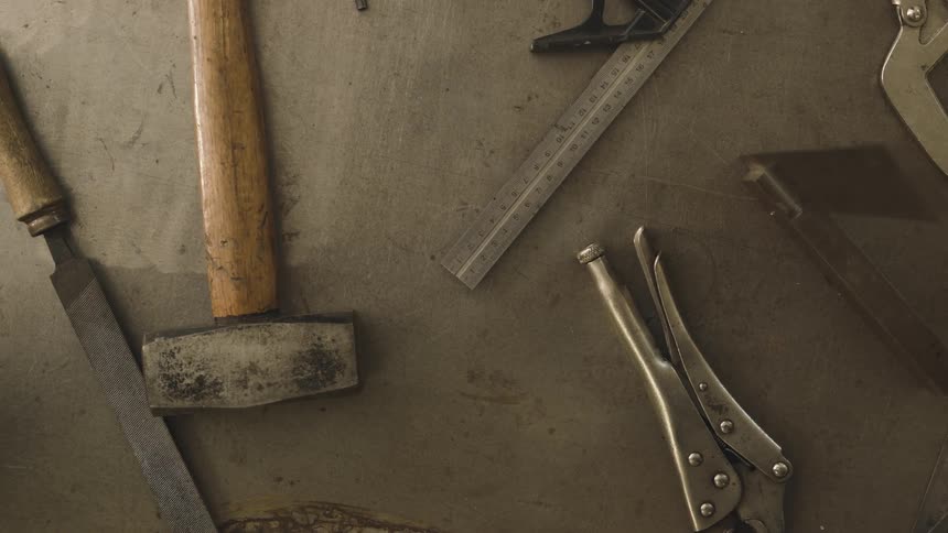 Overhead view of carpentry tools laying on a workshop counter