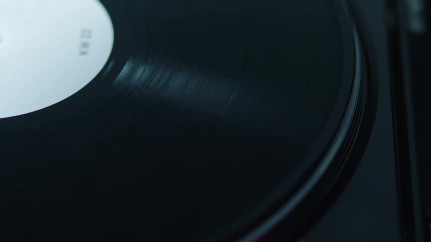 Closeup of a vinyl record on a vinyl record player