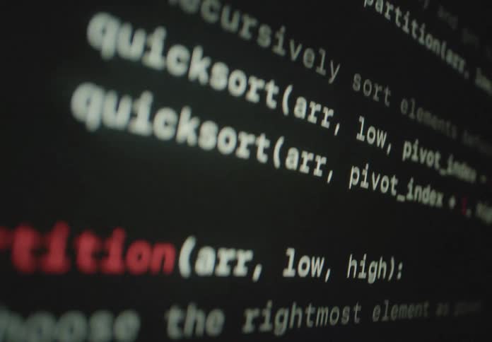 Screen shows the computer code being added to a computer program
