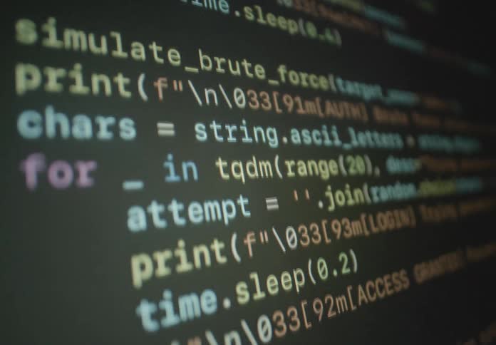 Lines of colorful computer programming code featuring terms like sniff protocols and bruteforce scroll across a dark screen