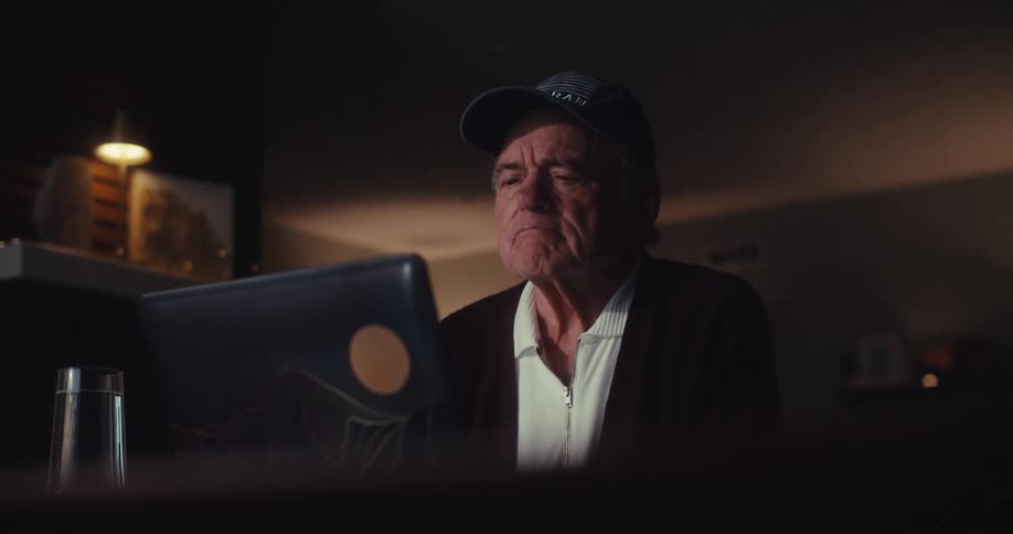 A man thinks carefully while using his laptop