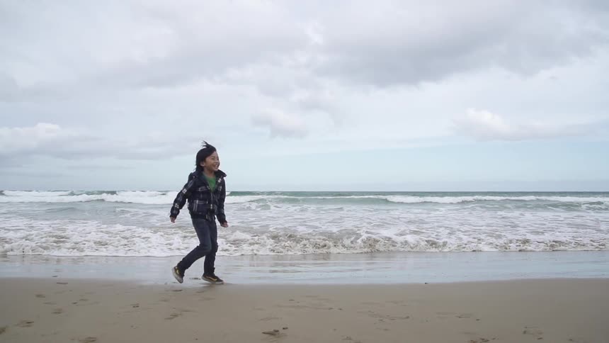 A child runs on the beach