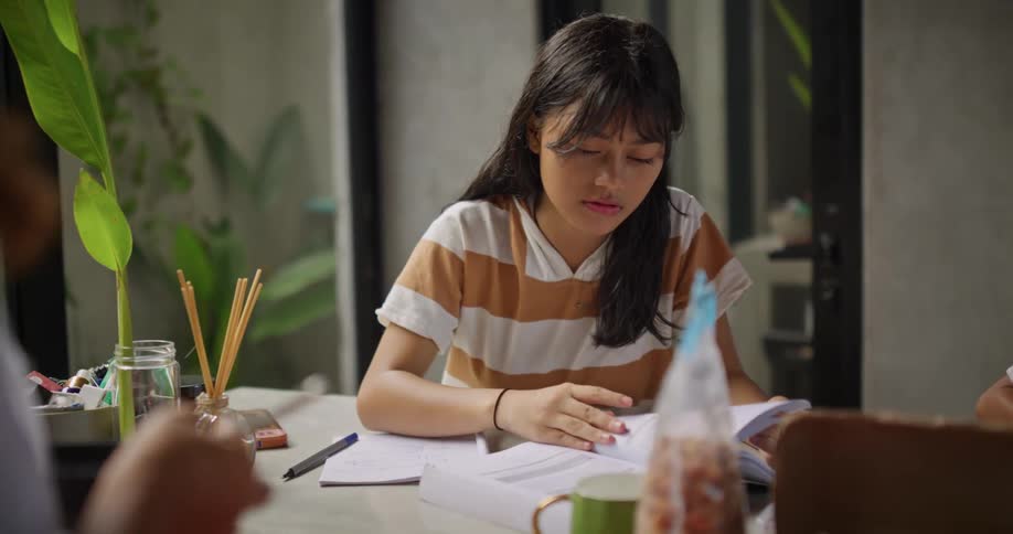 A mother is cooking with her children do homework