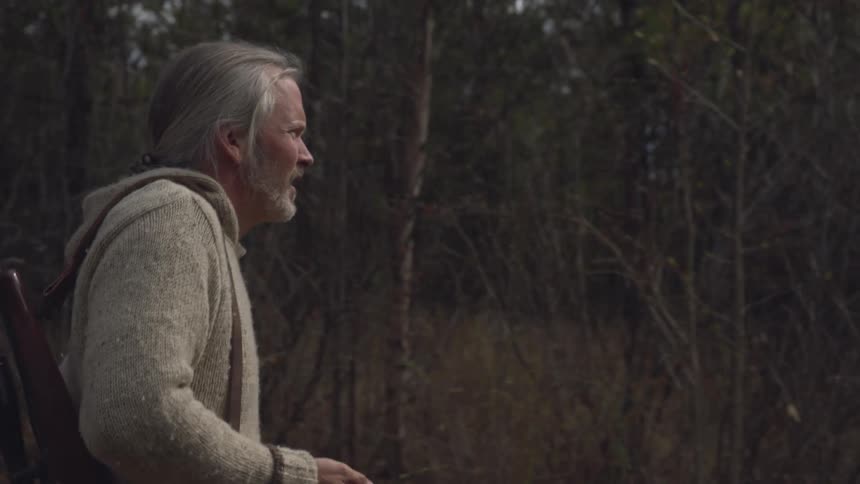 A man goes hunting in the woods