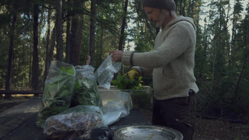 A man puts herbs in bags