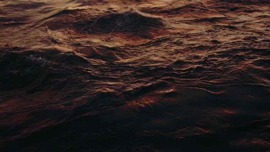 The colors of sunset are reflected on the ocean waves