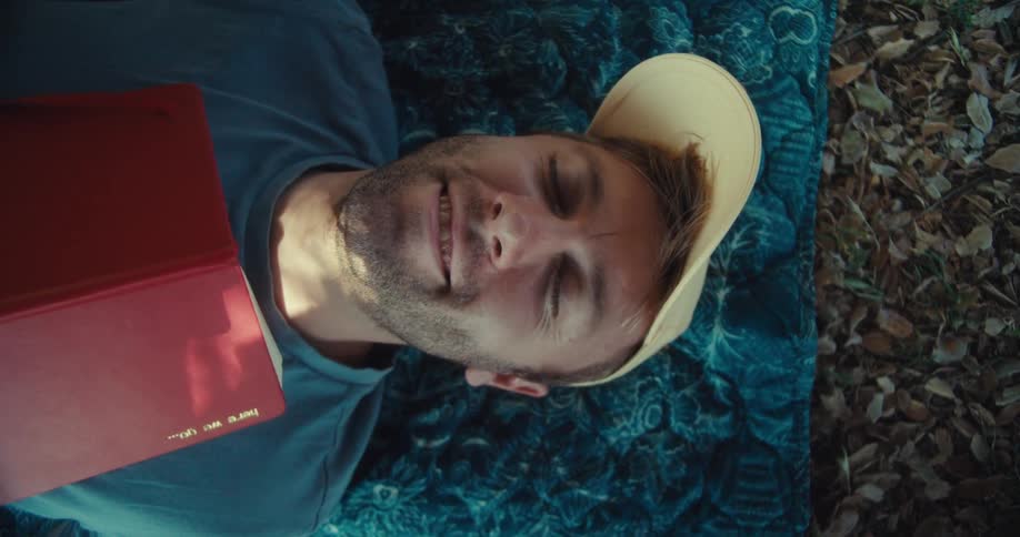 A man reads a book and looks thoughtful