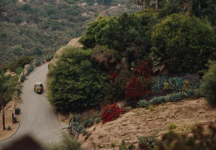 A small vehicle turns on the mountains winding road