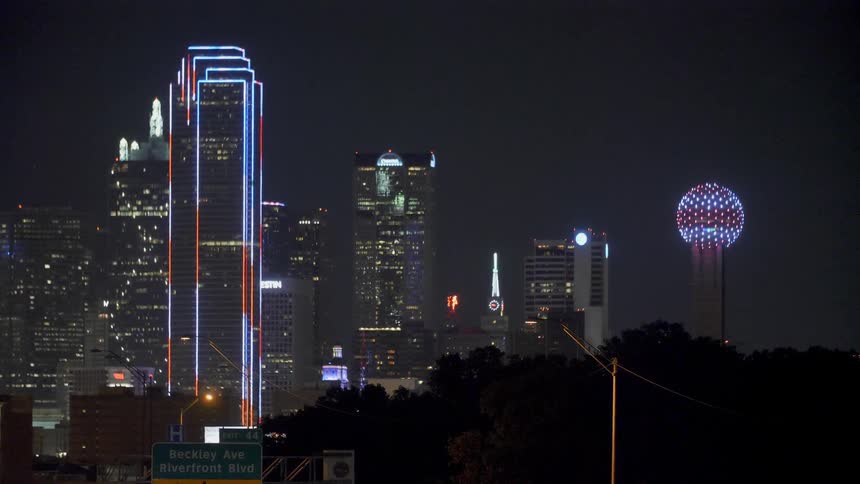 The buildings are brightly lit at night