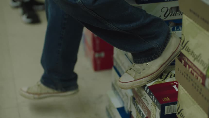 Legs of a person sitting on drink crates