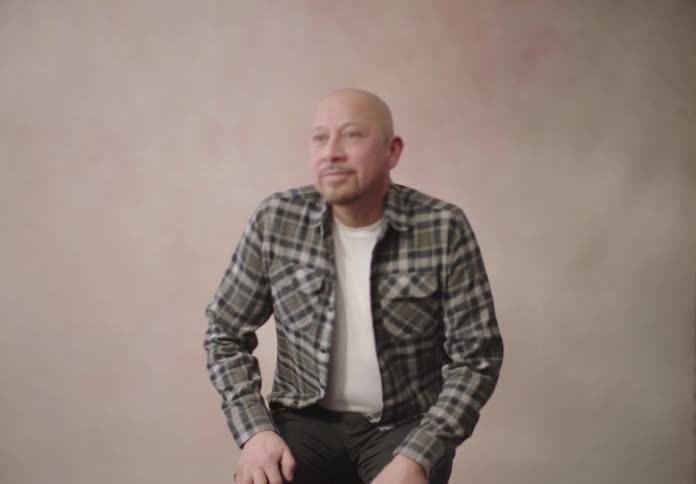Man sitting on a wooden chair