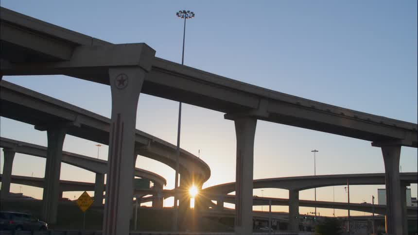 Time lapse of vehicles moving on the bridges of a highway during sunset