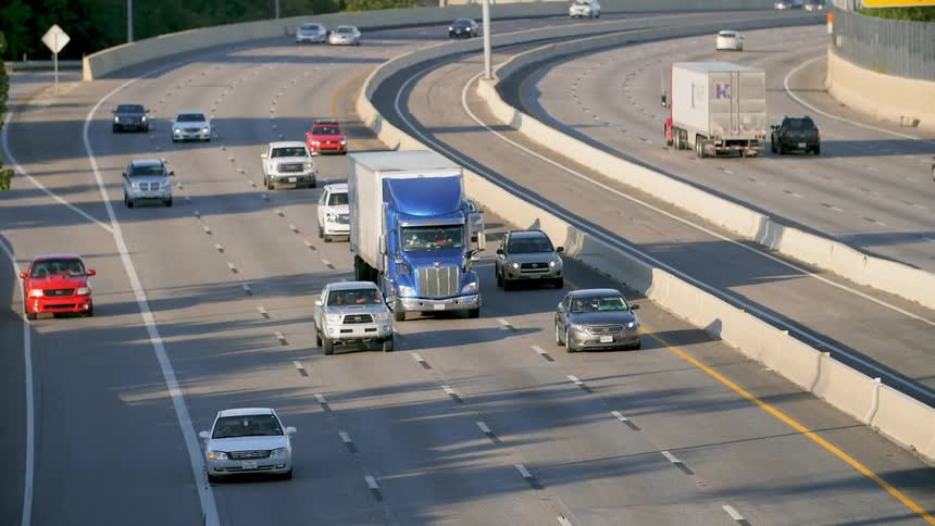 Vehicles move in slow motion on a city highway