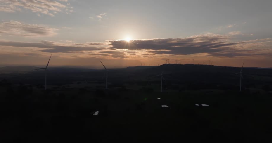 The sun is low in the sky making the land a silhouette