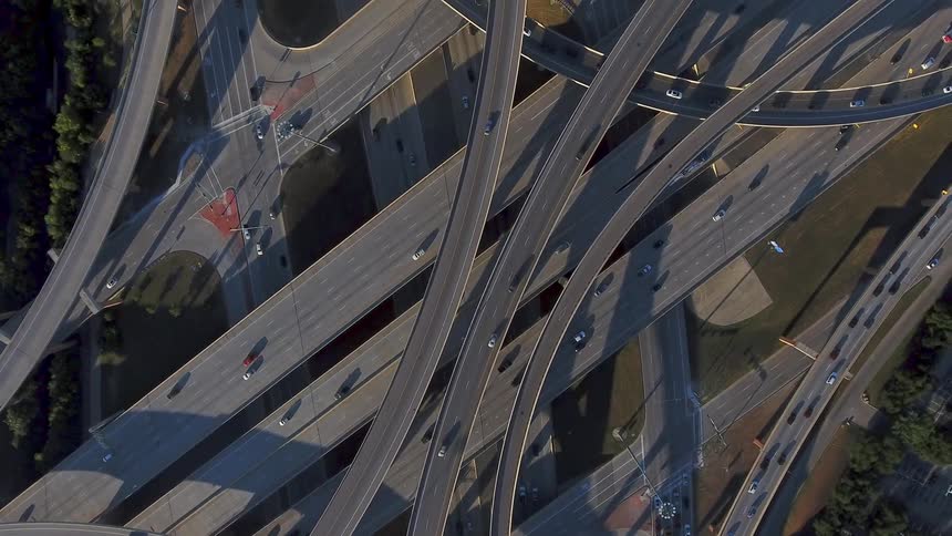 Cars drive on a highway system