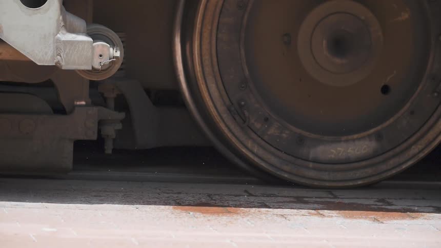 A close up view of a train wheel sitting on a track