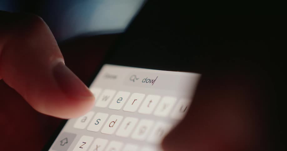 A person begins typing a word into their phone