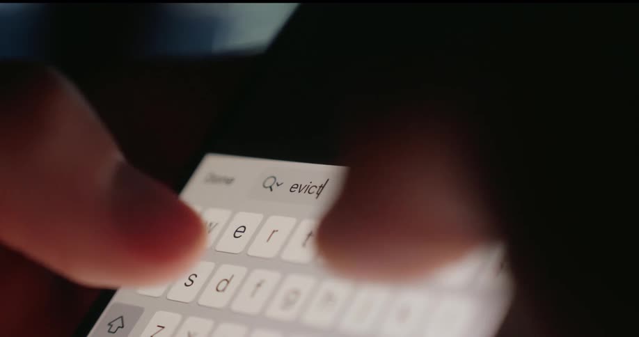 A person is using their cell phone and searching the word eviction