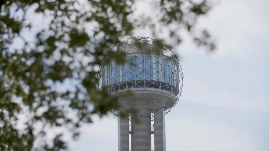 A water tower stands in the distance