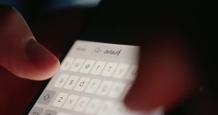 Closeup of a smartphone screen and a pair of hands typing