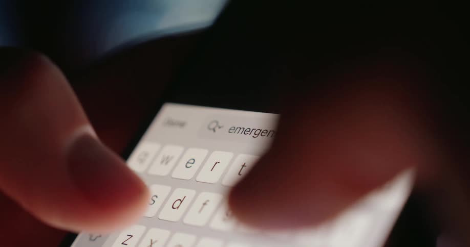 Pair of hands typing on a virtual keyboard of a smartphone
